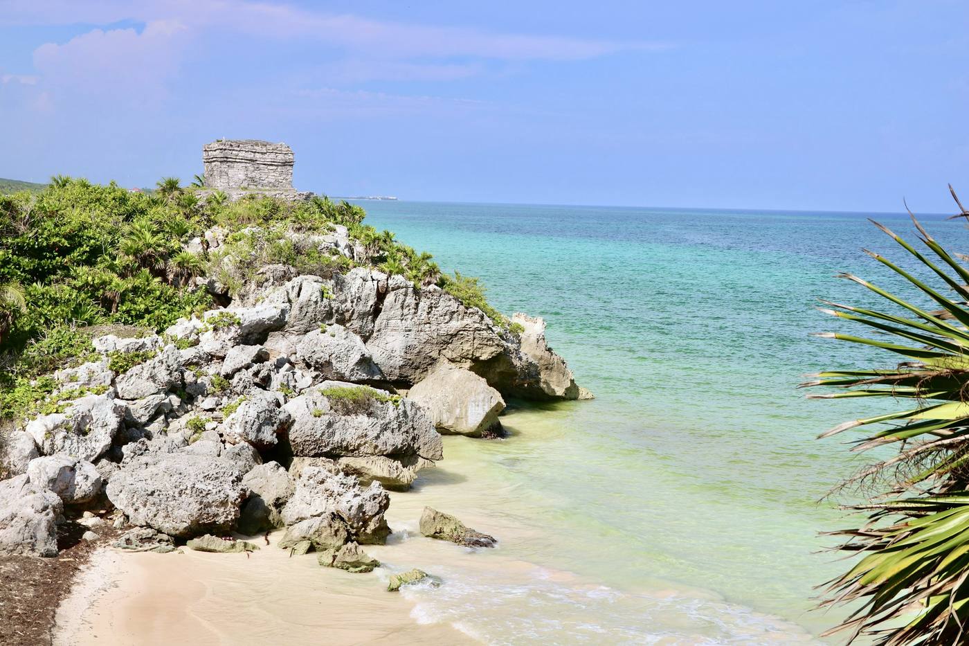 Mayan ruins above turquoise water at Tulum, Mexico
