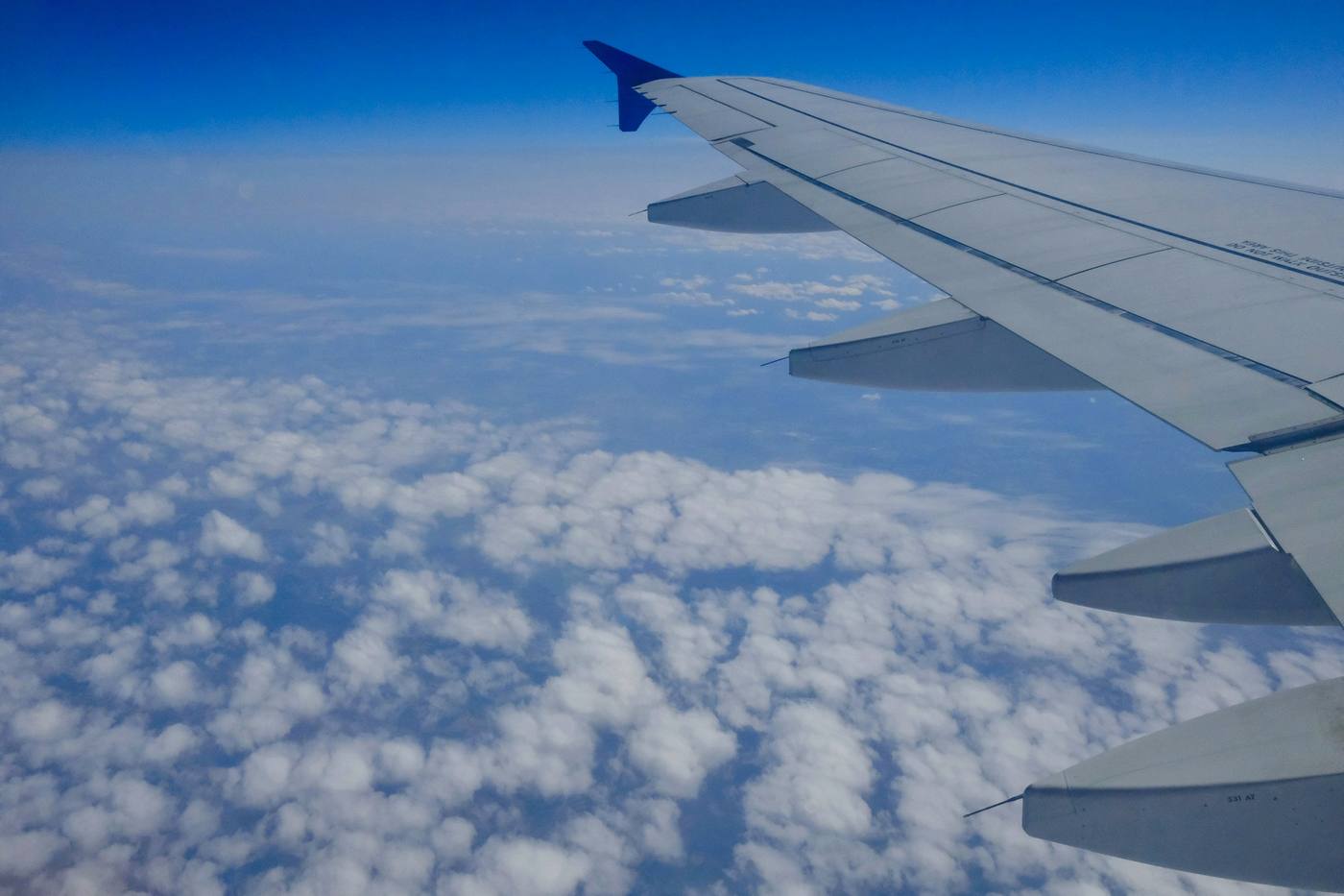 View from an aeroplane window over the clouds